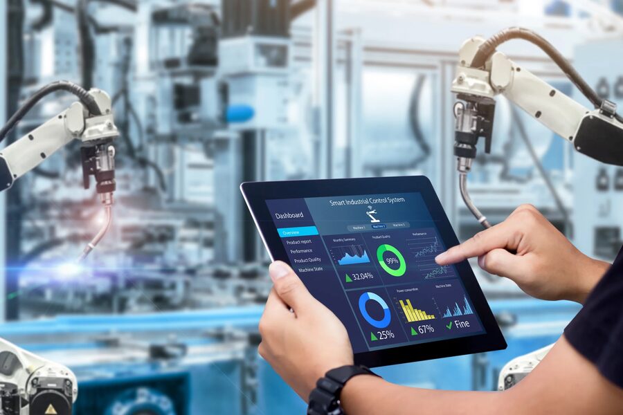 Technician monitoring an industrial robot from a tablet
